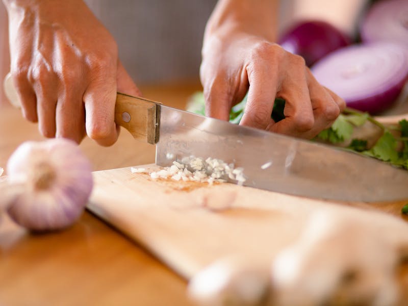 Fresh finely chopped garlic on chopping board