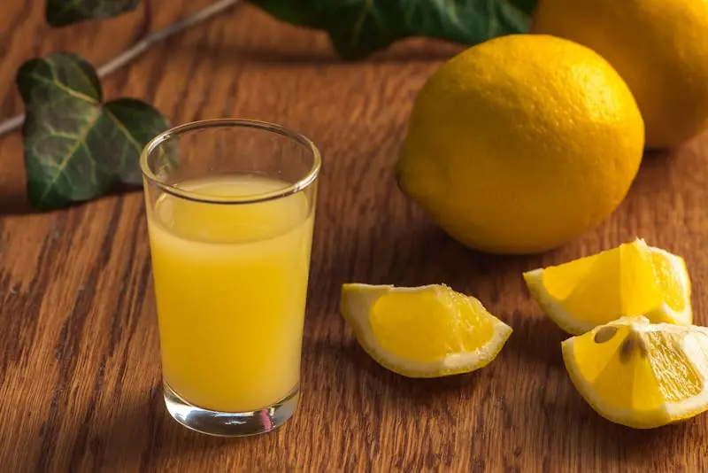 glass of lemon juice and lemons