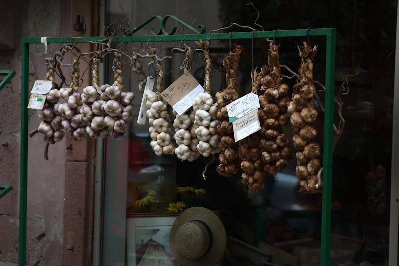 braids of garlic hanging outside the store