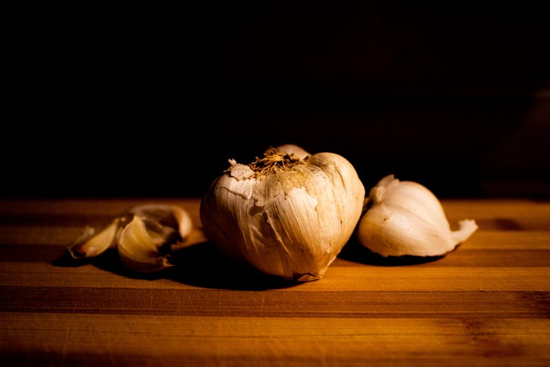 garlic bulbs on the table dark background