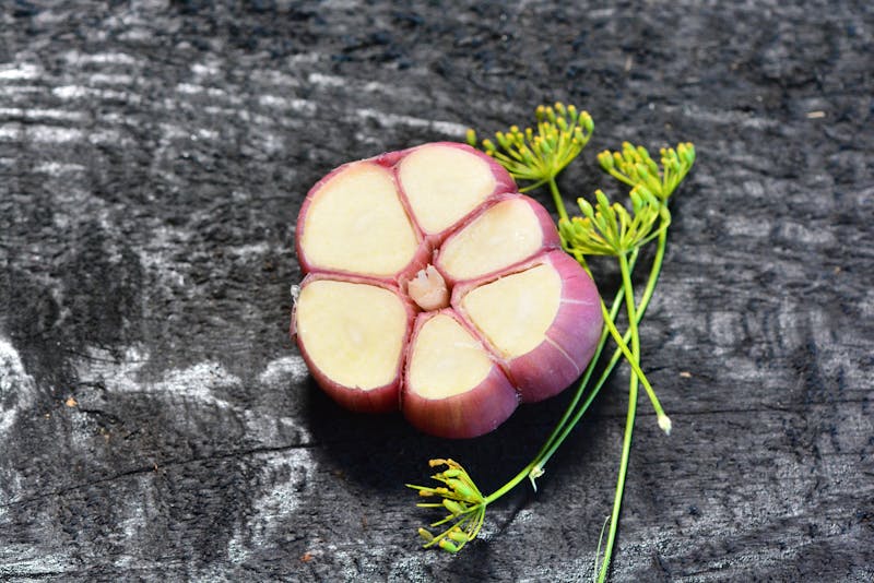 a purple garlic bulb cut in half