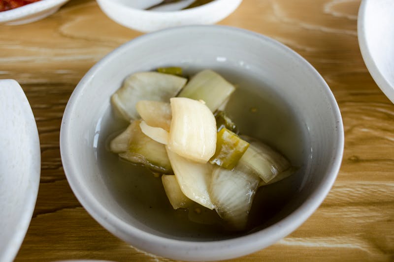 Soup with onion and garlic in white bowl