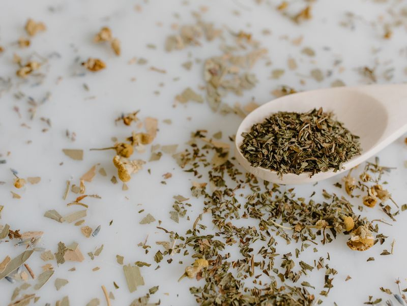 a big spoon with dried and crushed lemon balm