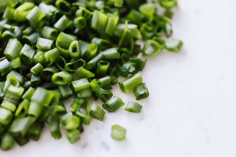 fresh garlic chives on white background