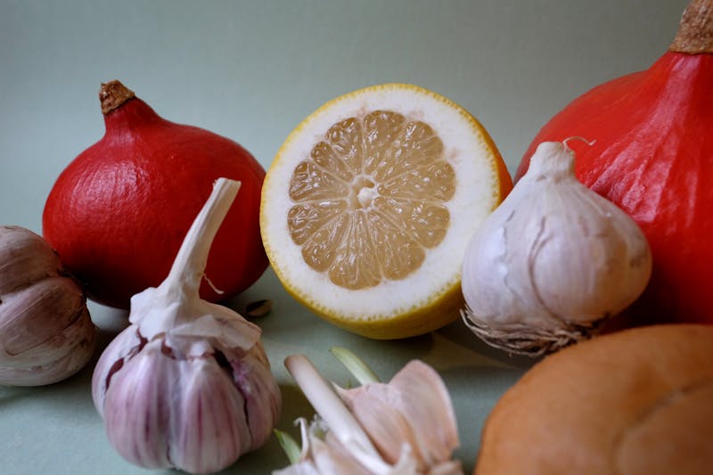 garlic bulbs with chopped lemon and pumpkins
