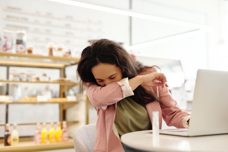 woman with allergies sneezing