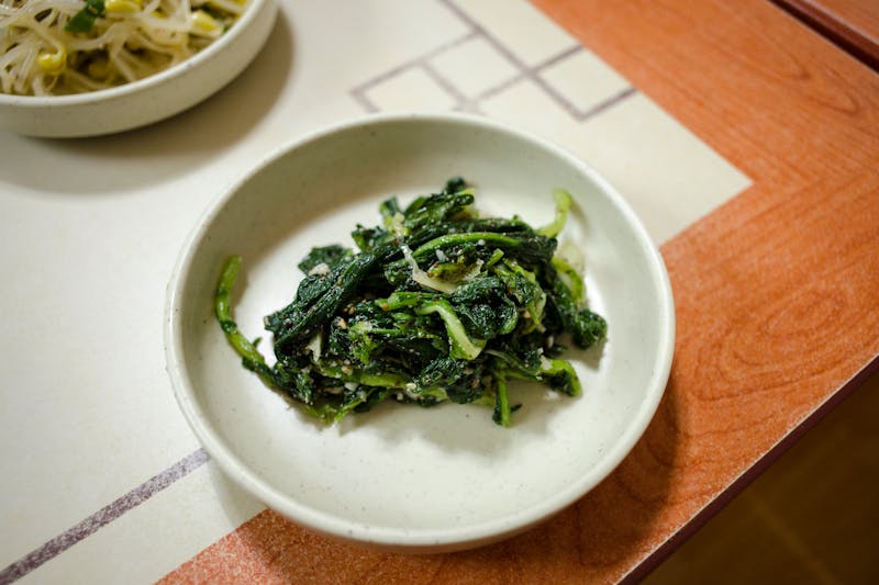 boiled spinach with garlic on a plate