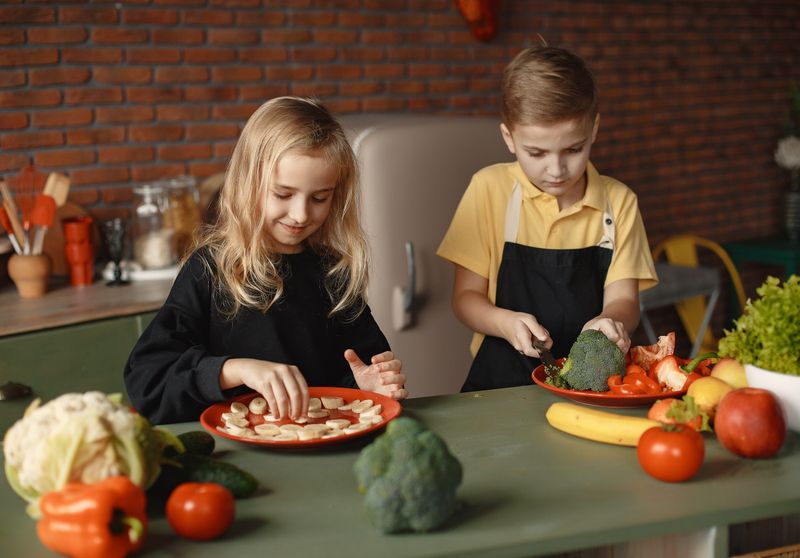 children in the kitchen cooking a meal