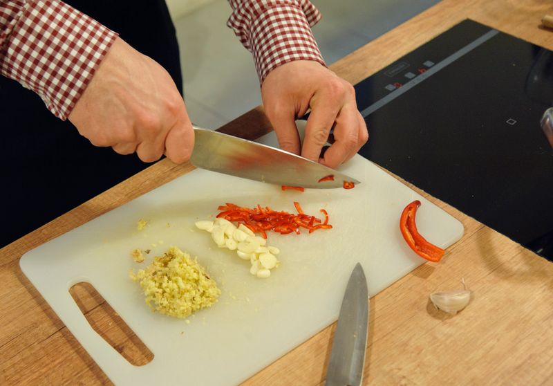 chopped garlic and red pepper on chopping board