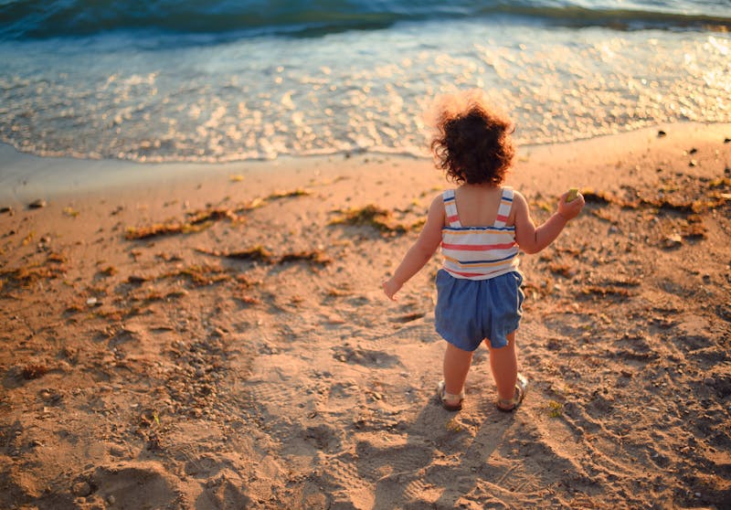 happy toddler on the beach by the sea