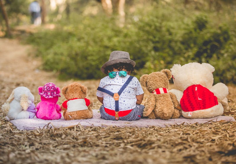 sad toddler sitting with toys