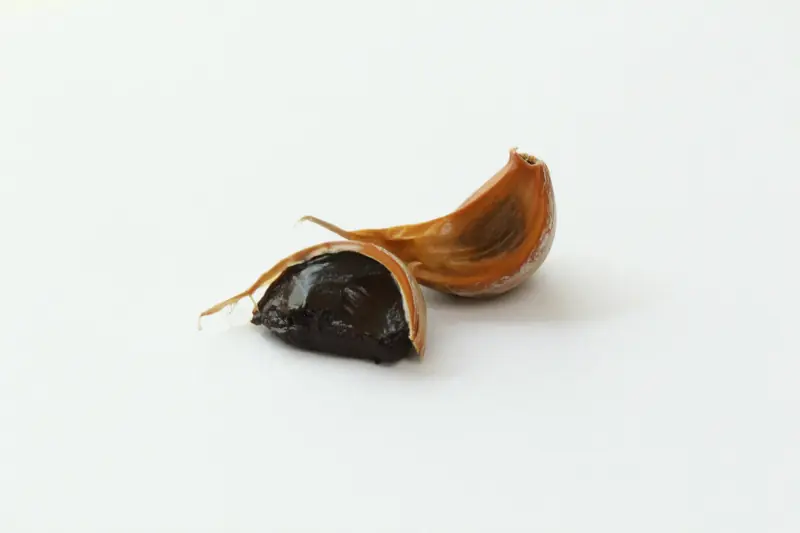 black garlic cloves white background